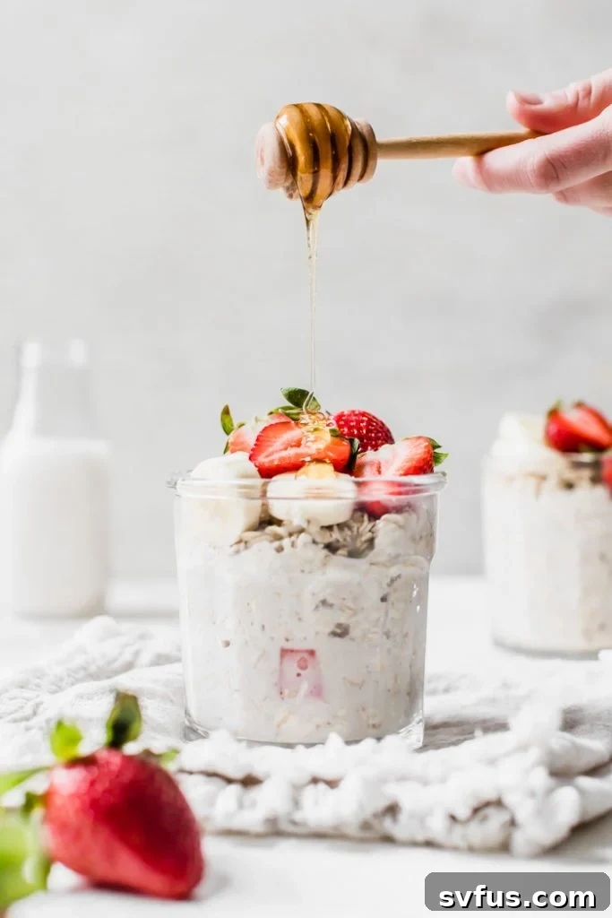 Overnight oats in a glass jar with fresh fruit on top, ready for a healthy breakfast.