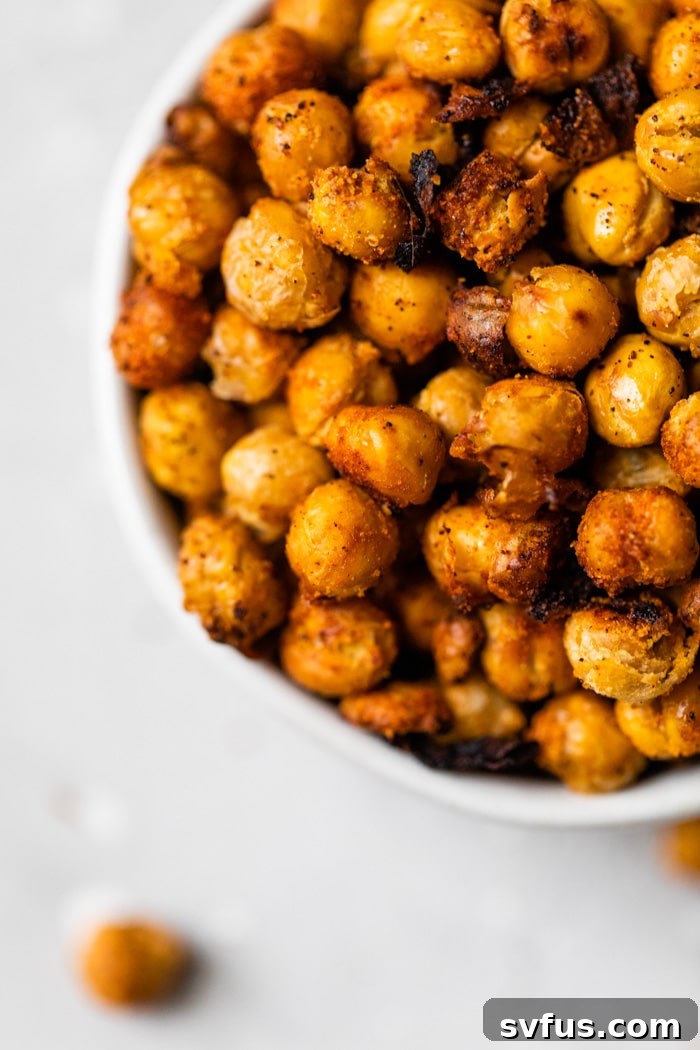 A final shot of crunchy roasted chickpeas, beautifully seasoned and arranged in a serving bowl, showcasing their golden crispiness.