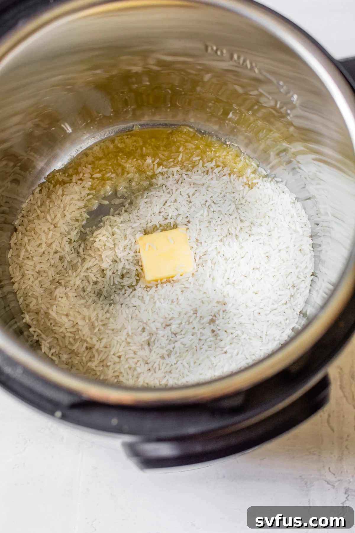 rice and butter in a pressure cooker