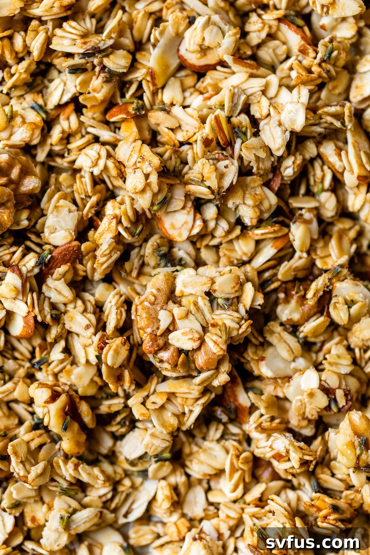 Close-up of golden-brown lavender granola baking on a sheet