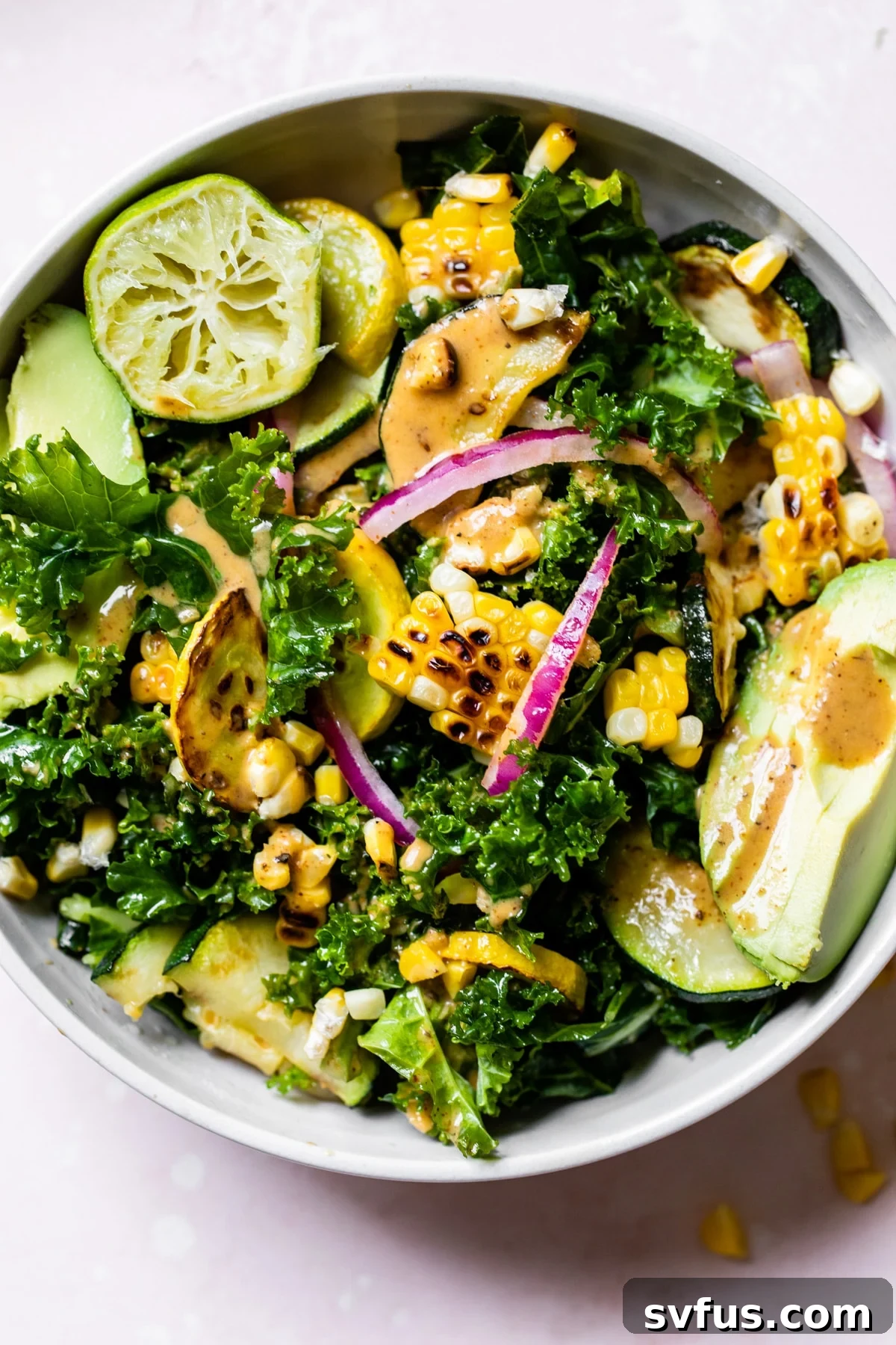 A beautifully presented Grilled Corn Kale Salad in a rustic bowl, showcasing the vibrant colors of kale, charred corn, avocado, and chili-lime dressing.
