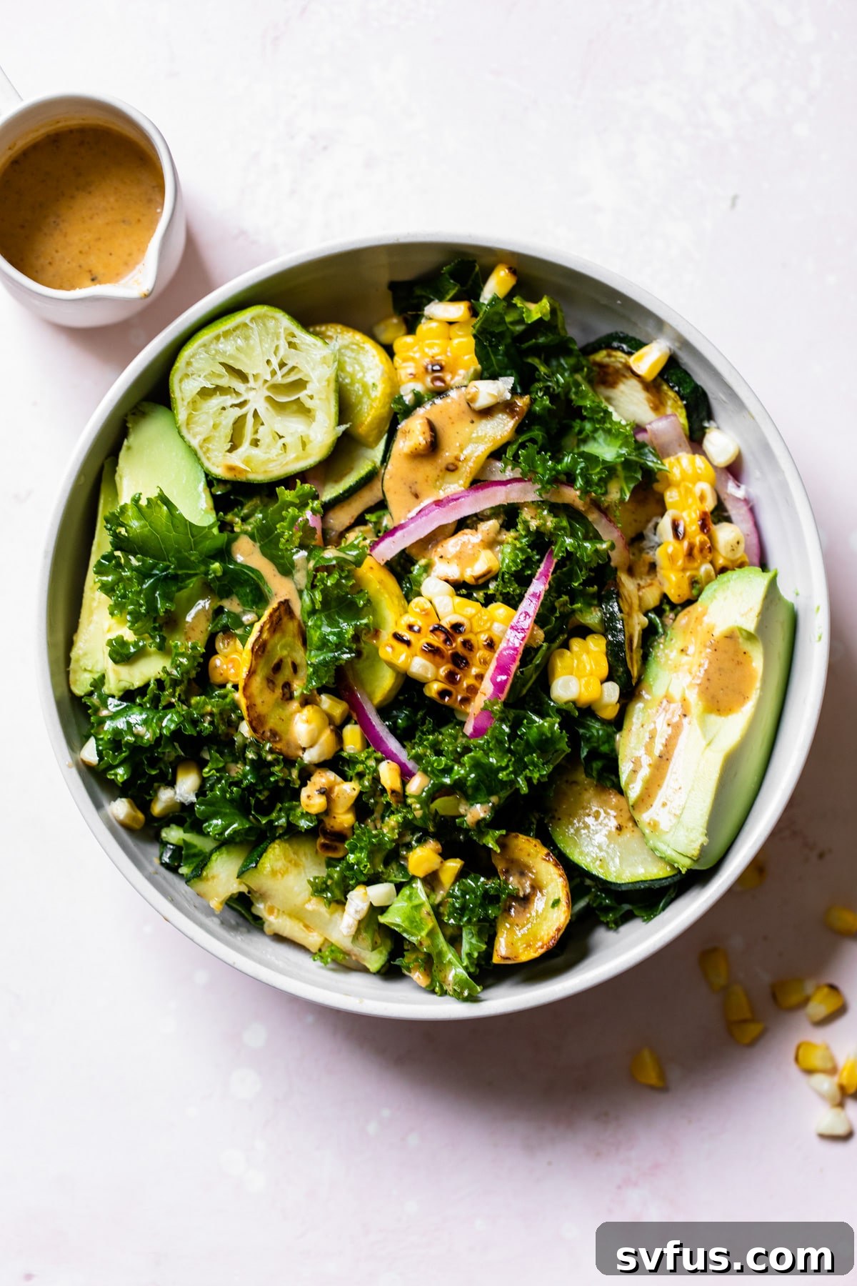 A large, vibrant bowl of Grilled Corn Kale Salad, garnished with fresh herbs and ready to be served, capturing the essence of healthy eating.