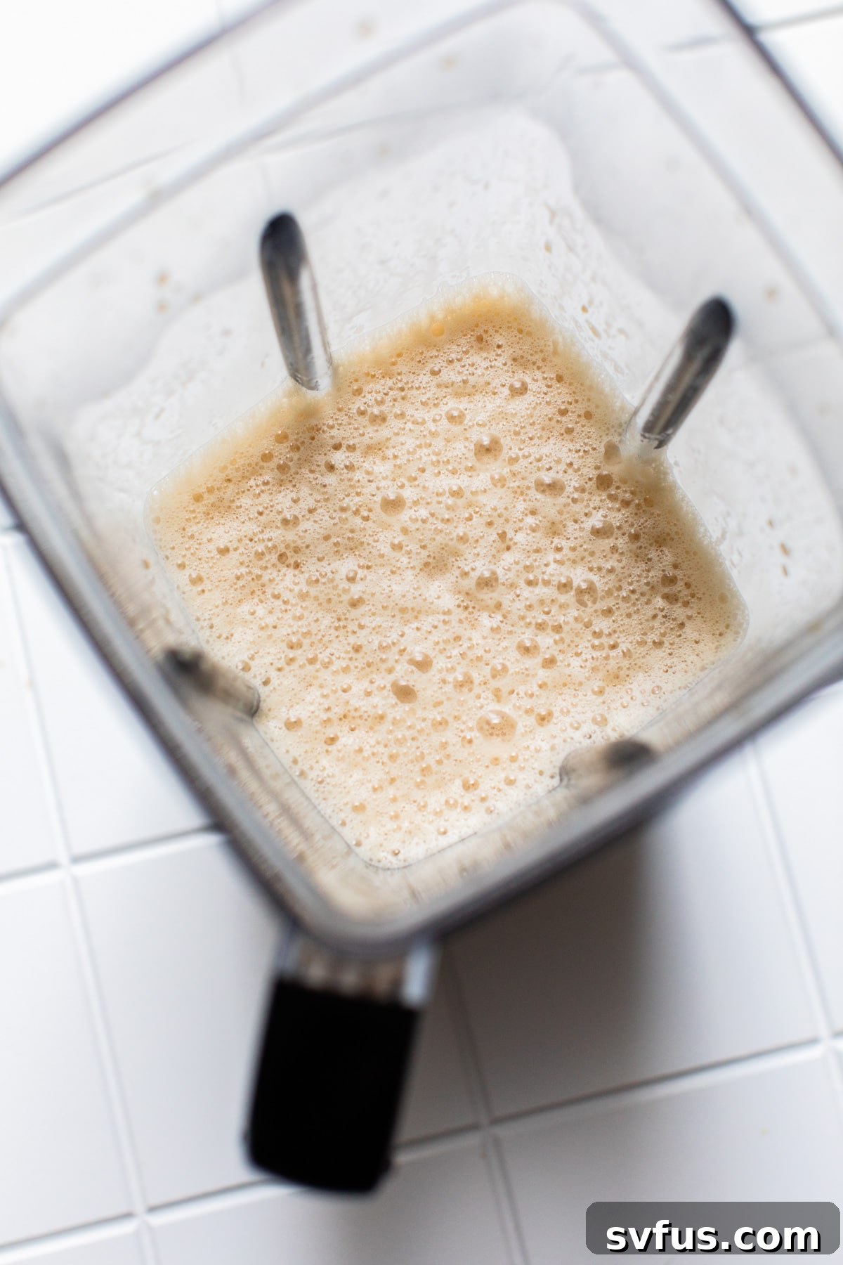 Iced Bulletproof Coffee ingredients blending in a high-speed blender for a creamy texture