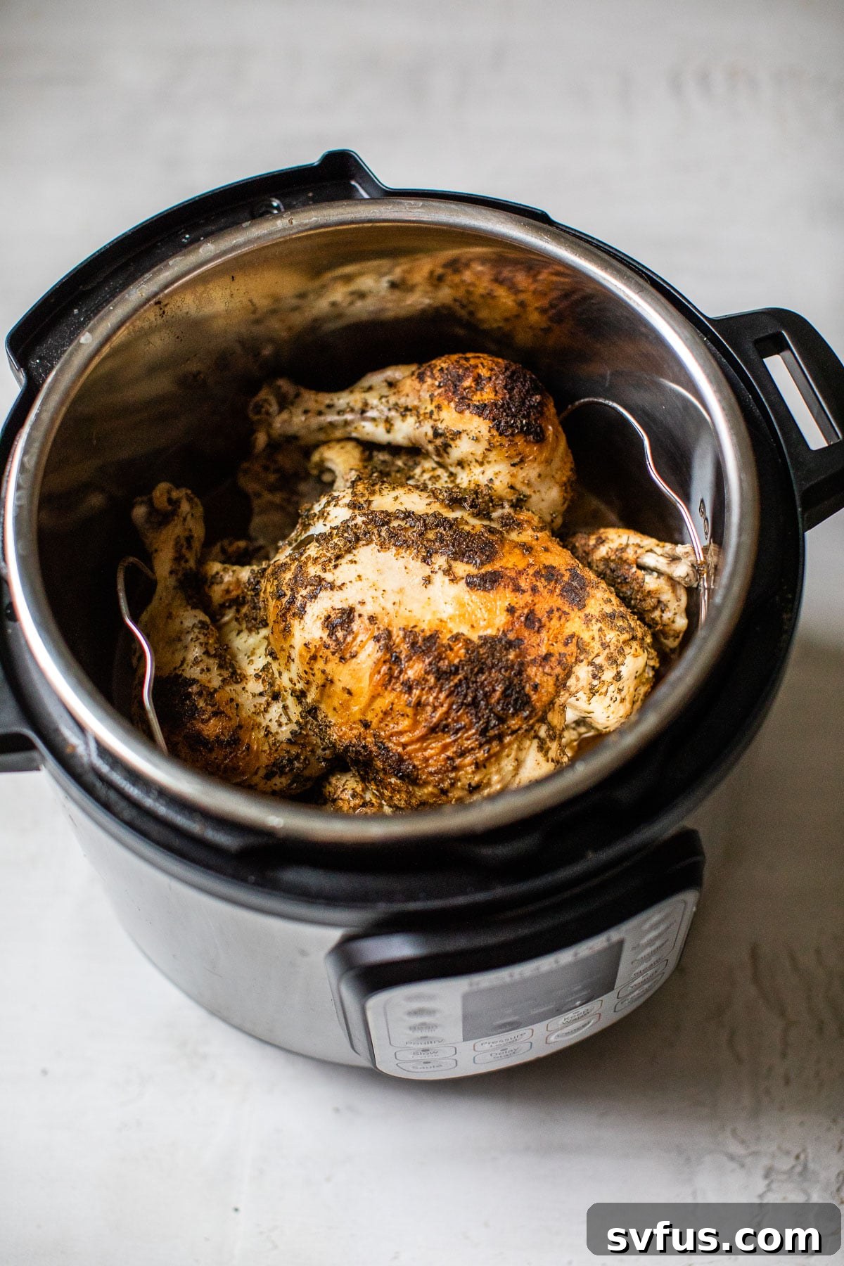whole chicken inside of a pressure cooker