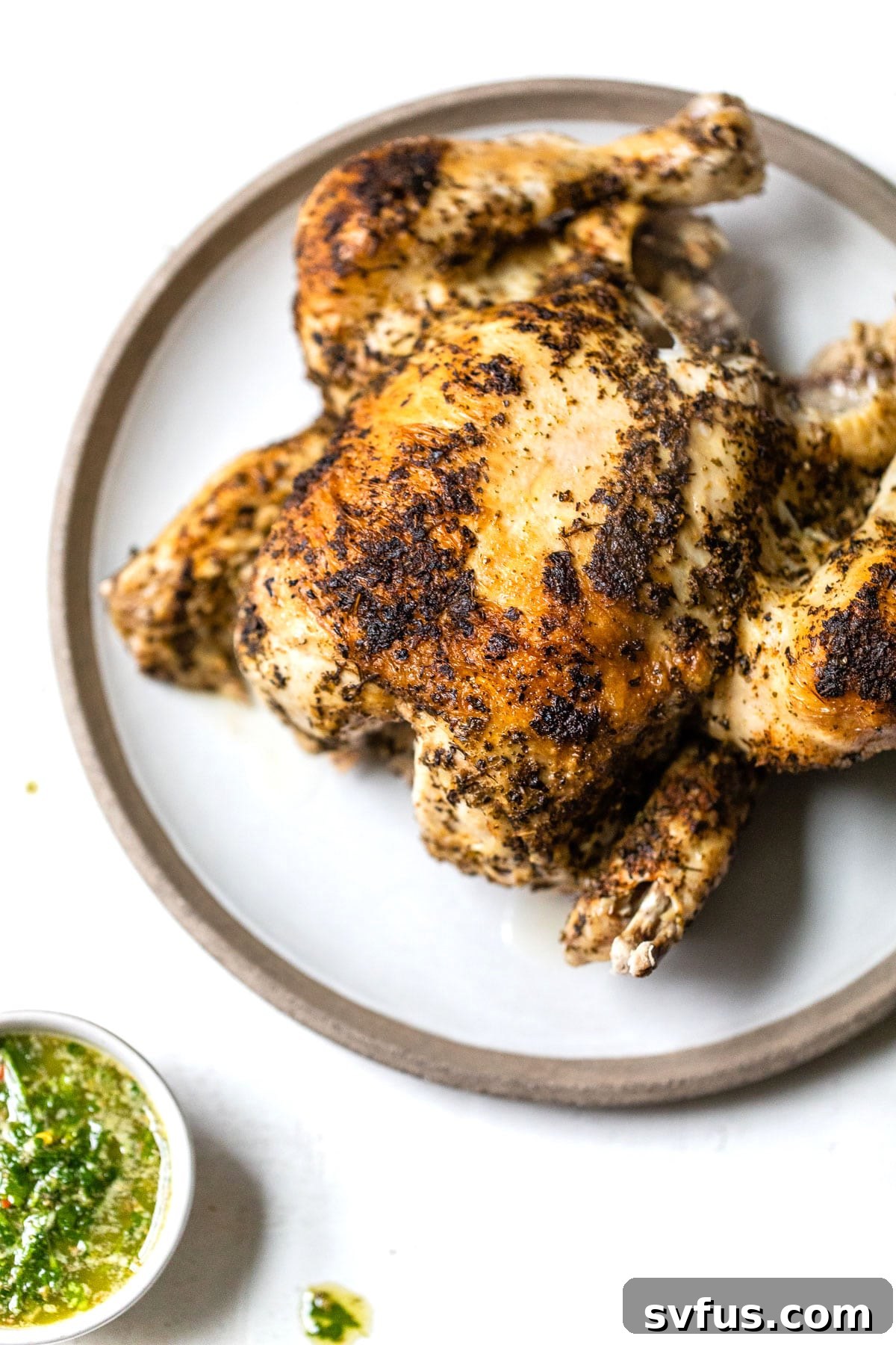 cooked whole rotisserie chicken on a plate
