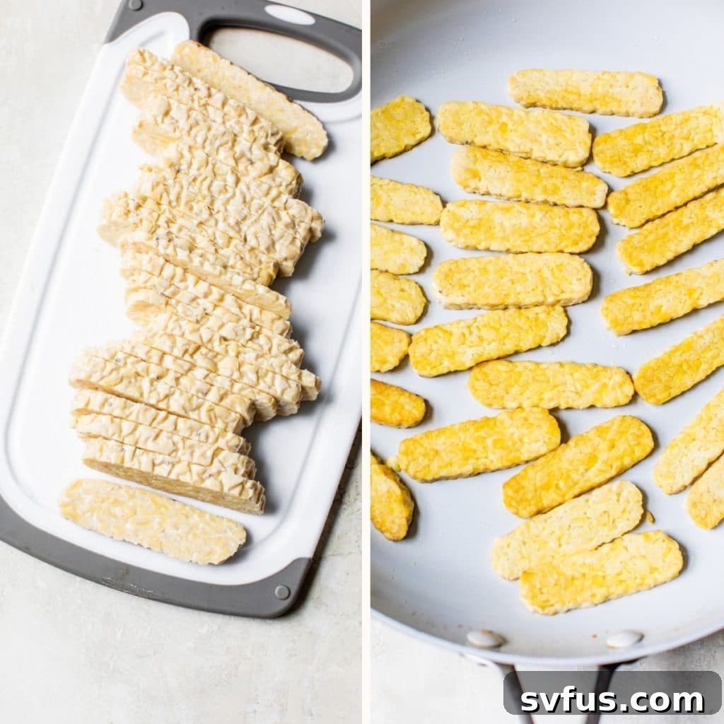 Thinly sliced tempeh strips laid out on a cutting board, ready for cooking.