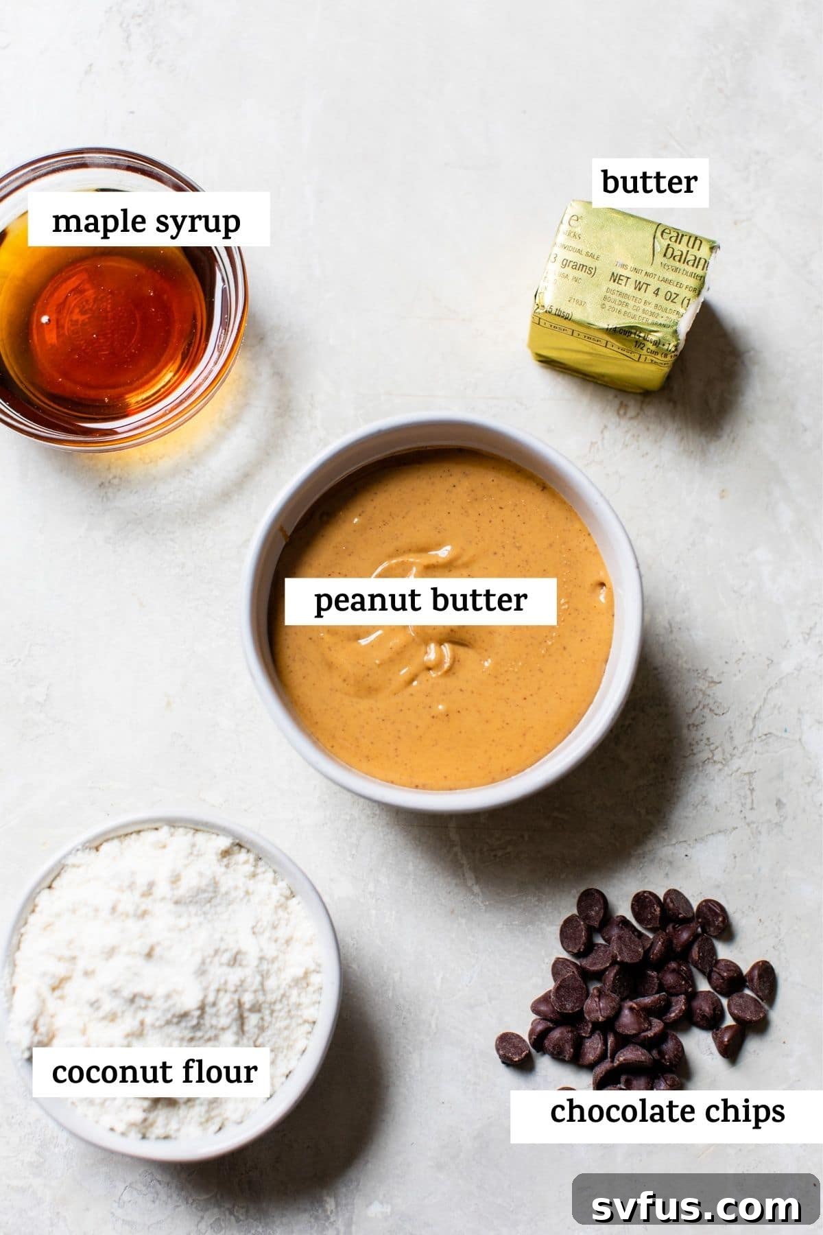 Close-up of the simple, wholesome ingredients used to make healthy peanut butter balls, arranged on a rustic surface.