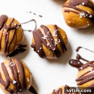 peanut butter balls with a chocolate drizzle