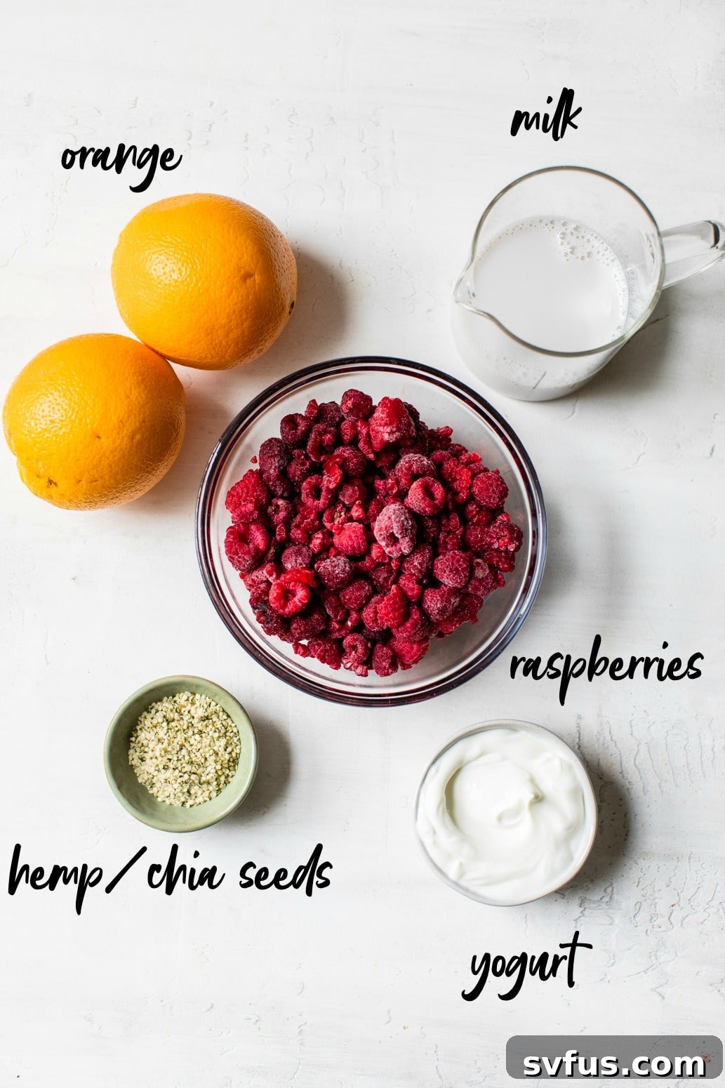 ingredients to make a raspberry orange smoothie with text overlay, including oranges, raspberries, milk, and yogurt
