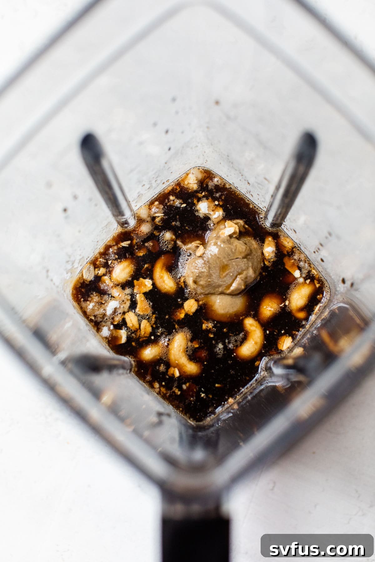 blender filled with cashews and coffee