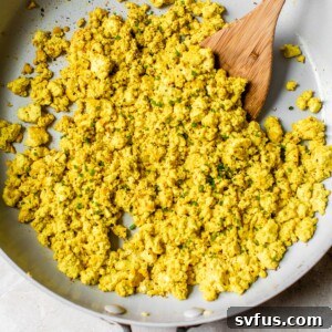 faux eggs topped with chopped chives in a skillet