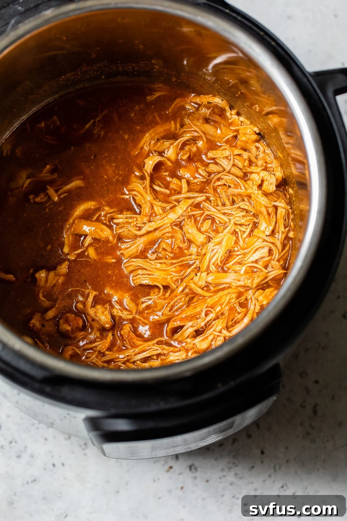 shredded chicken with bbq sauce in a pressure cooker
