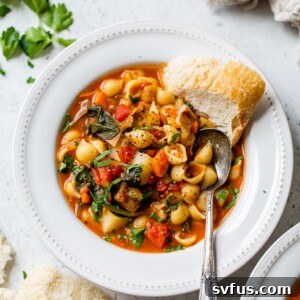 bowl of soup with a side of bread