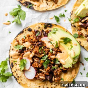 Close-up of a taco on parchment paper with cilantro