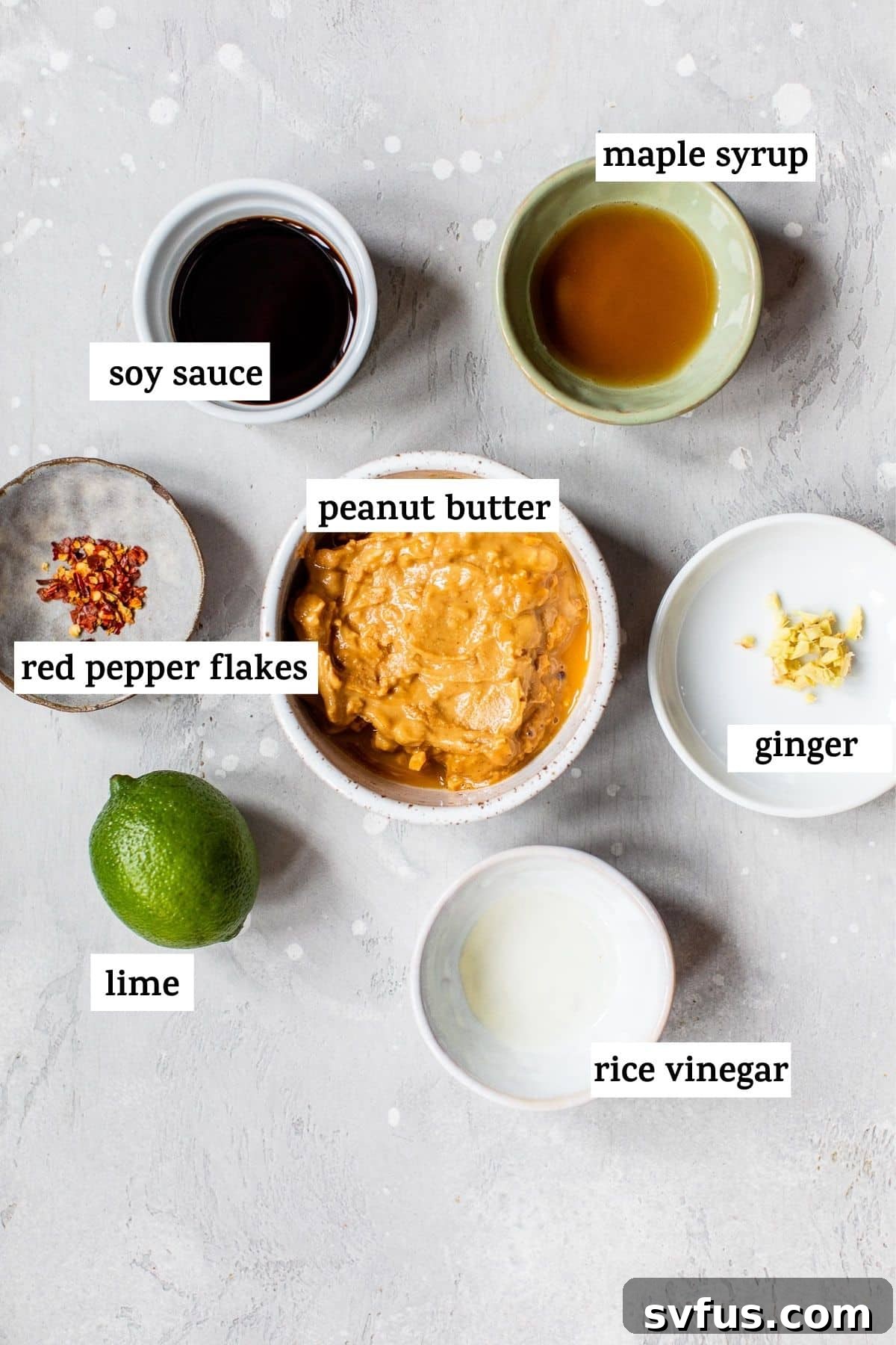 All the simple, fresh ingredients laid out on a wooden board for making the Thai peanut sauce