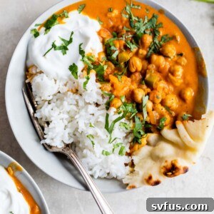 rice, naan and marinated chickpeas in a bowl with cilantro