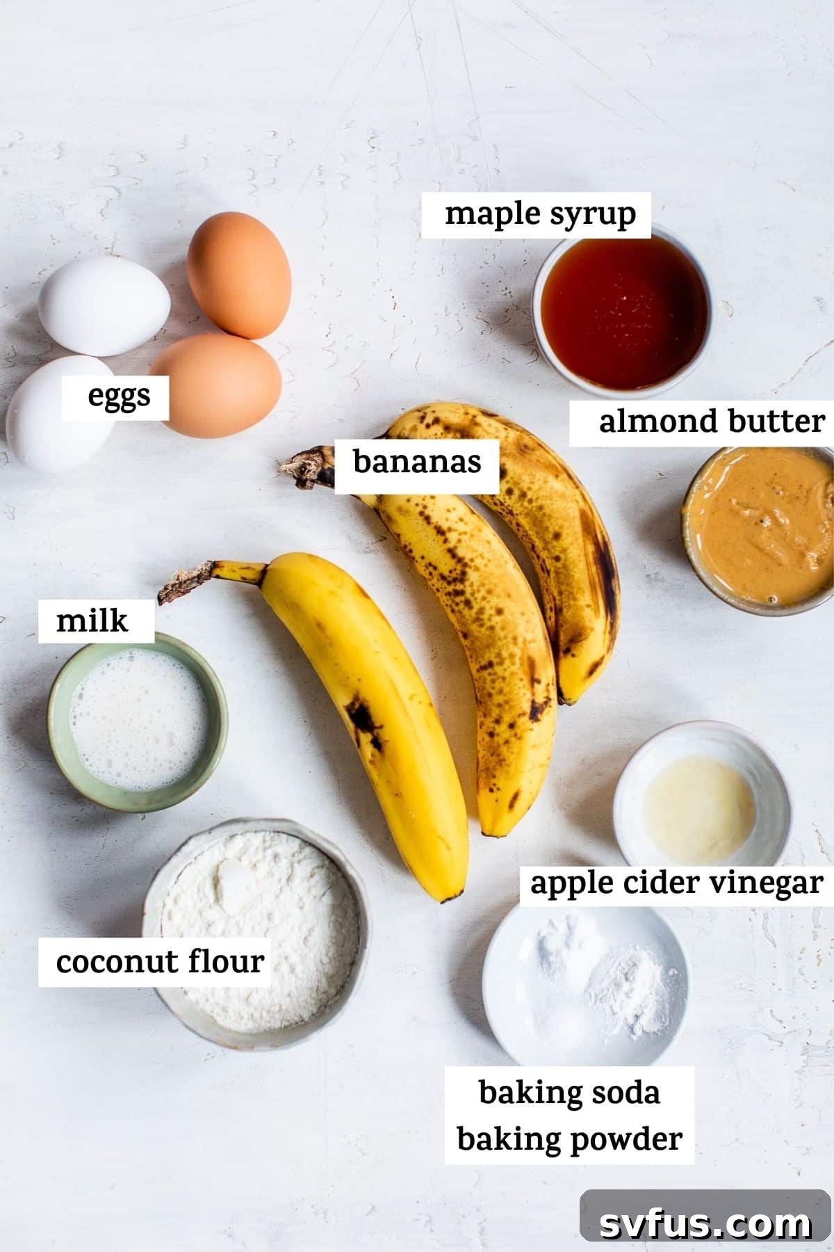 A flat lay of fresh, ripe bananas, coconut flour, eggs, and maple syrup, the essential ingredients for making healthy banana muffins.