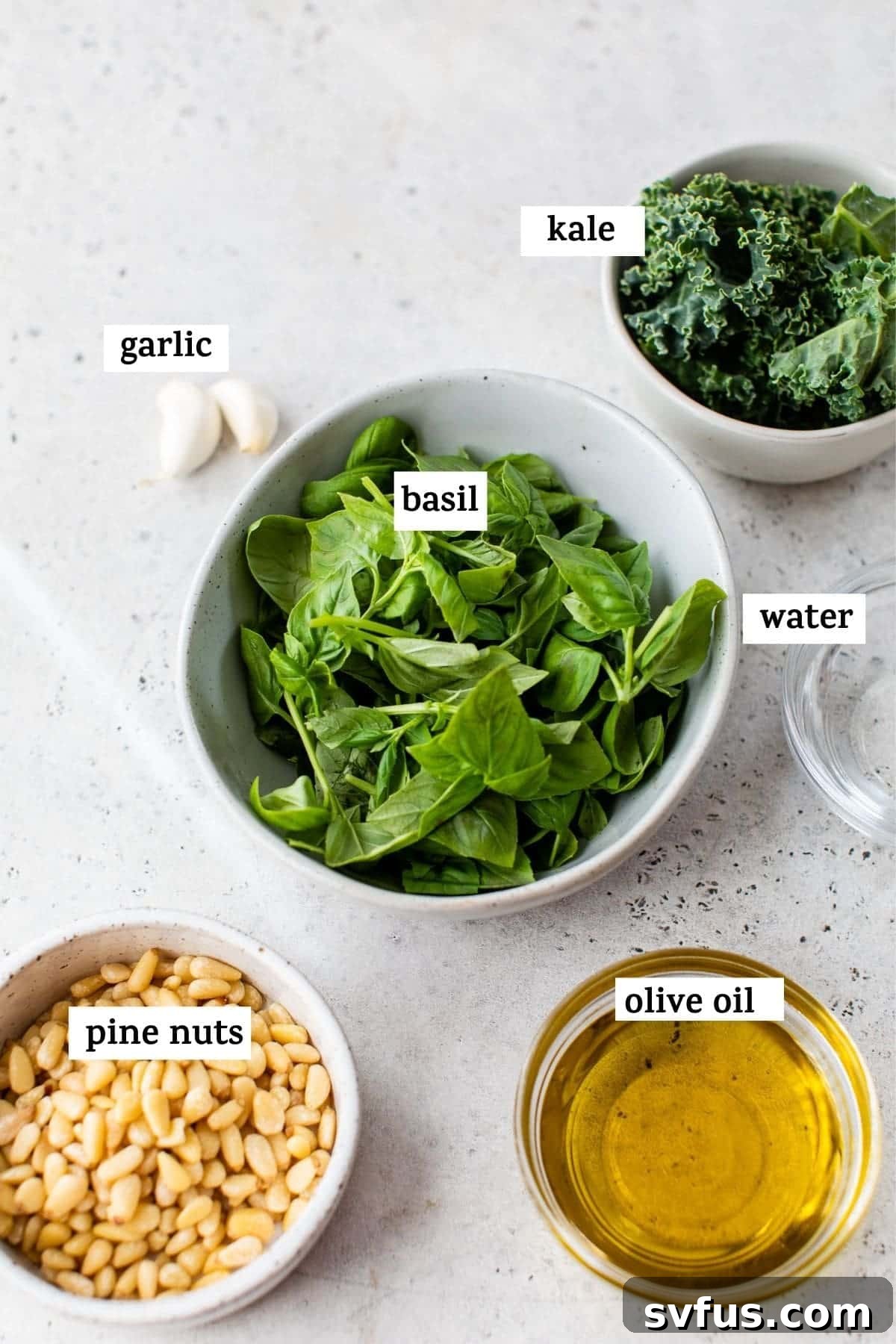 A second view of the vibrant green kale pesto in a bowl, showcasing its smooth texture.