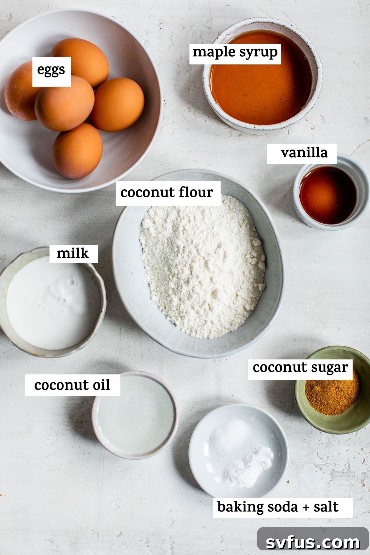 A vibrant flat lay of all the essential ingredients laid out to make a delicious Coconut Flour Cake, accompanied by a text overlay detailing the key components.