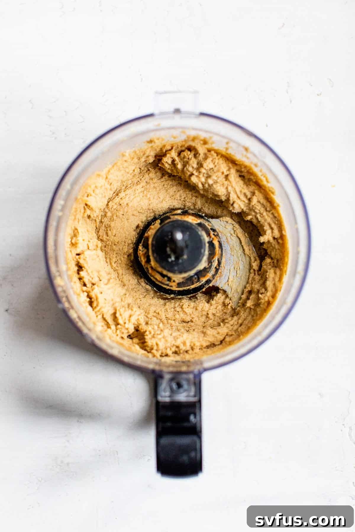 Smooth, blended chickpea cookie dough mixture in a food processor.