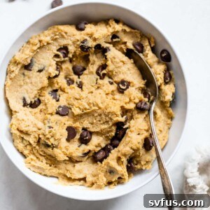 big bowl of cookie dough with chocolate chips and a spoon