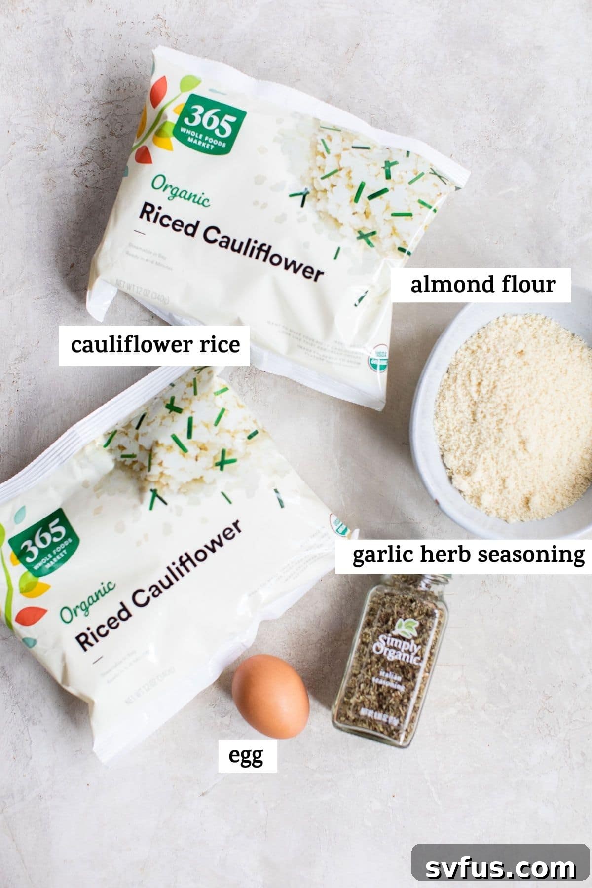 A flat lay of ingredients laid out, including cauliflower rice, almond flour, an egg, and a blend of Italian seasoning, ready for making cauliflower pizza crust.