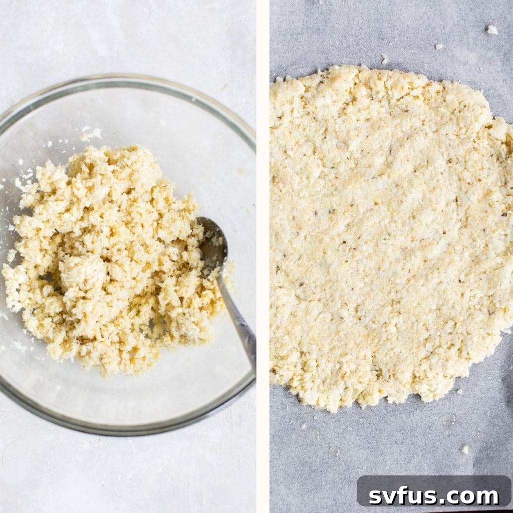 An uncooked cauliflower pizza crust, perfectly shaped and ready for baking on parchment paper.