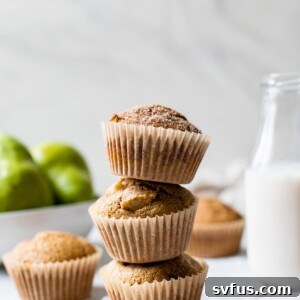 A stack of three pear and cinnamon muffins, perfectly golden and ready to eat.