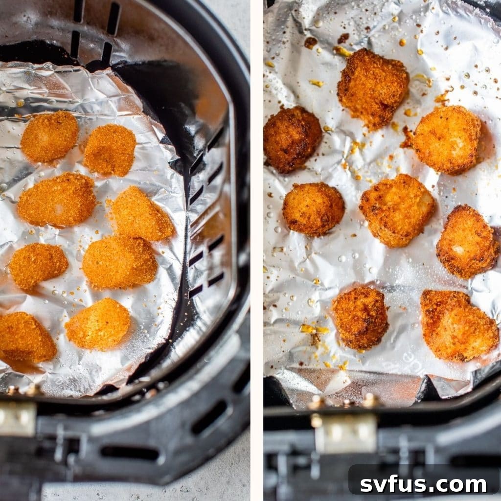 Breaded scallops neatly arranged in an air fryer basket, cooking to a golden crisp.