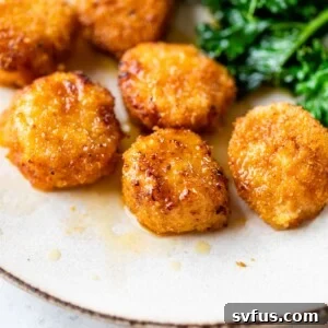 breaded fried scallops on a plate topped with melted butter
