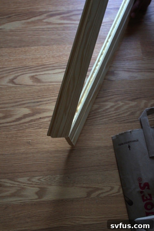 Wiping away excess wood glue from the seam of the planks