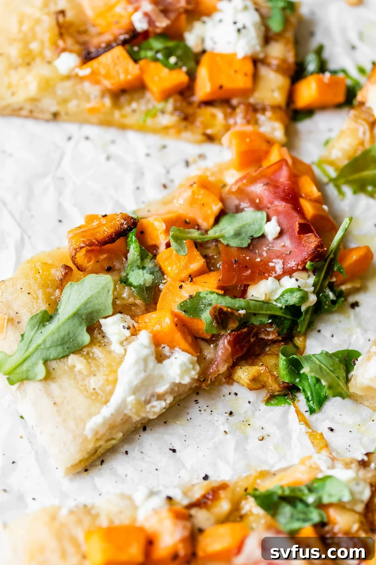 Delicious slices of Sweet Potato Pizza topped with caramelized onions and goat cheese, ready to be served.