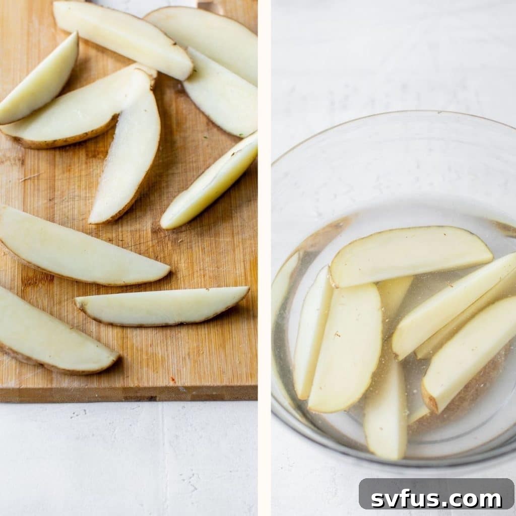 potato being sliced on a wooden cutting board