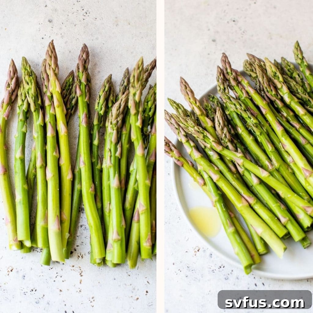 Raw asparagus spears drizzled with olive oil and seasoned with salt and pepper on a white plate