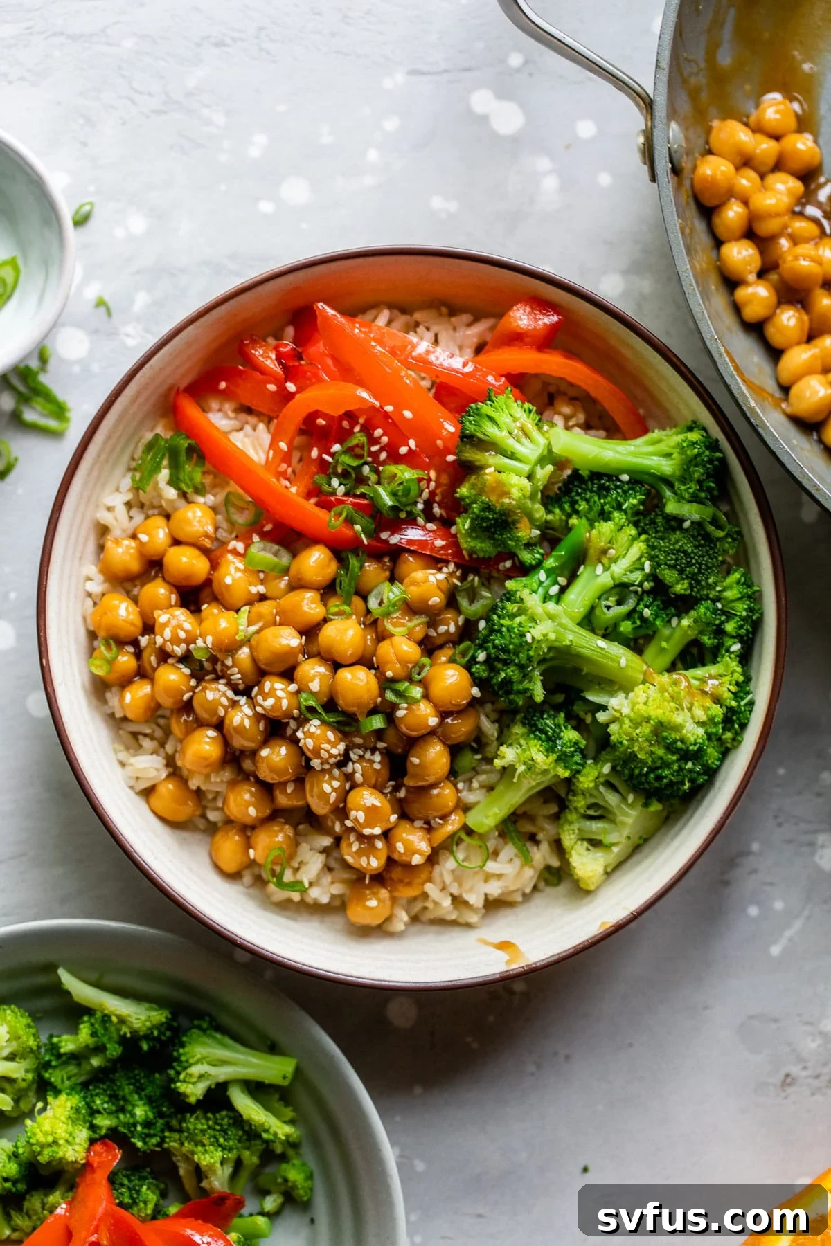 bowls with rice, chickpeas, broccoli, and bell pepper