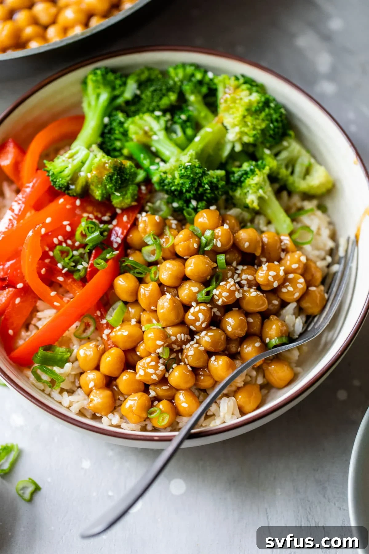 bowl filled with rice, broccoli, red bell pepper, and marinated chickpeas