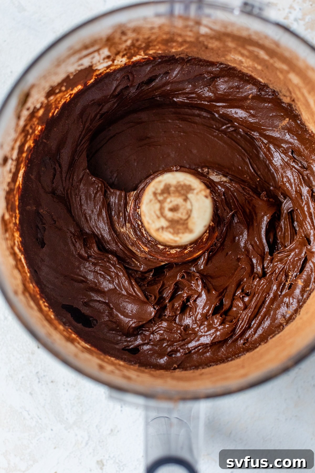 chocolate avocado pudding being processed in a food processor, showcasing its creamy texture.