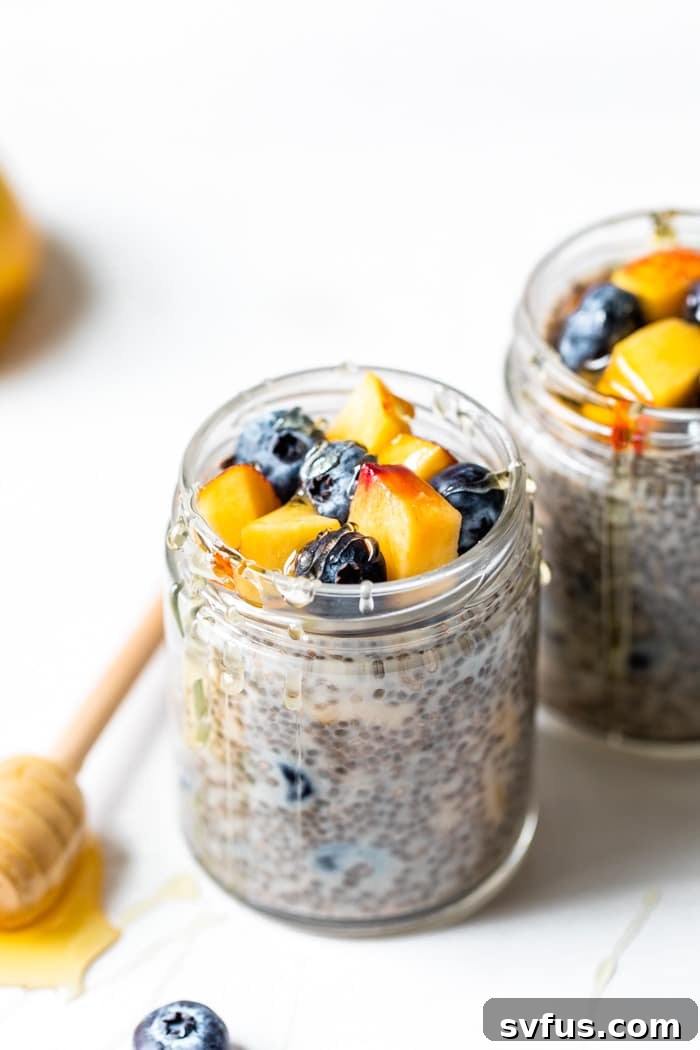 jar of chia seeds and milk topped with nectarine and fresh blueberries