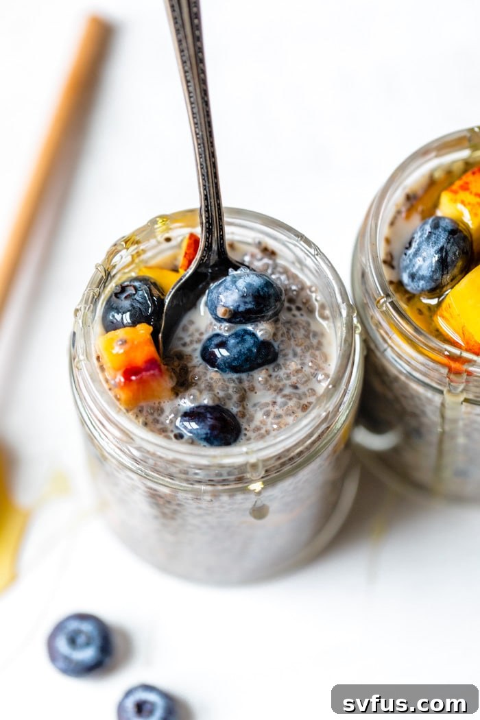jar of chia seeds and milk with fresh blueberries