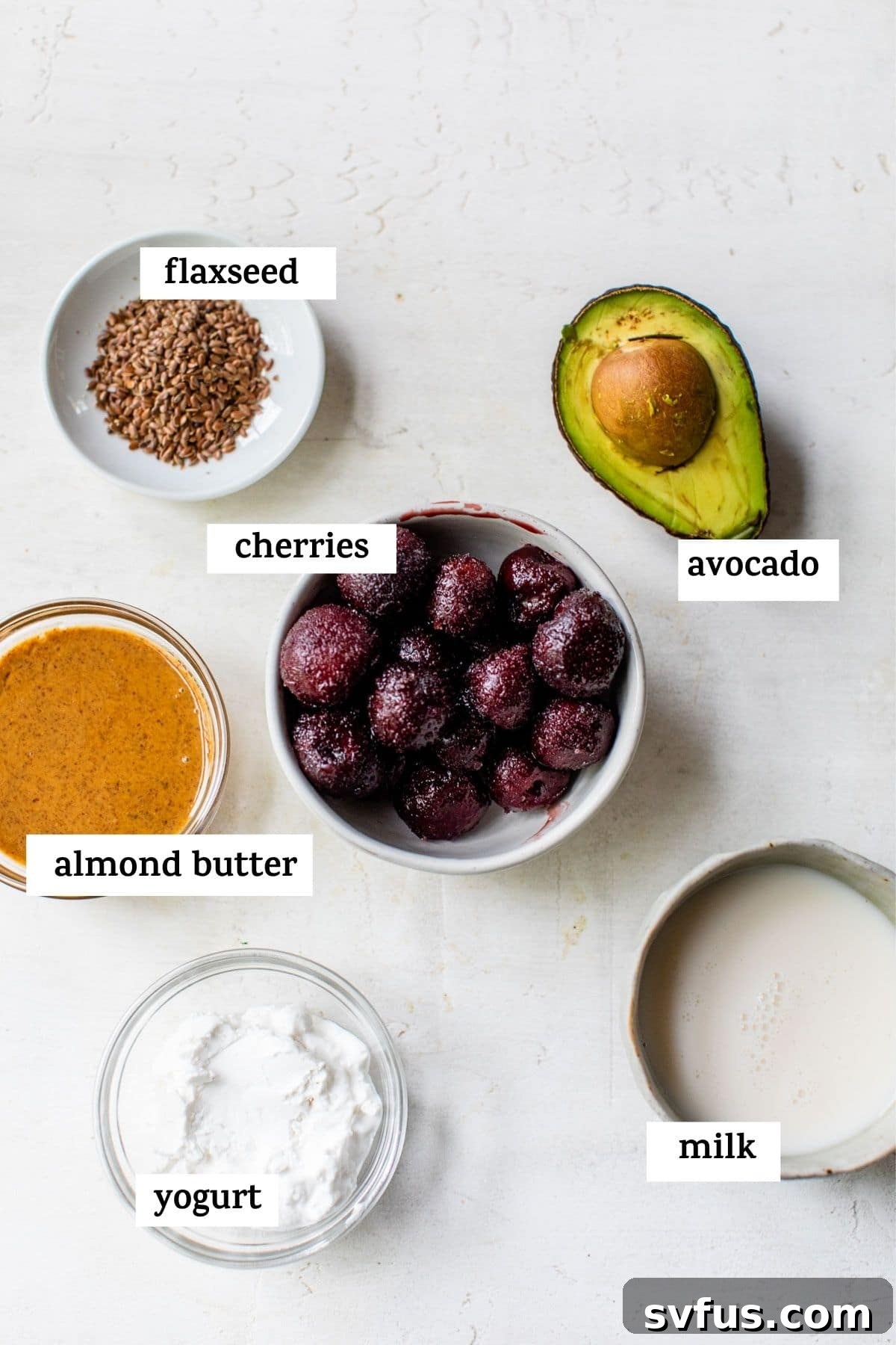 All the vibrant ingredients for making a delicious cherry smoothie laid out on a clean surface, with a text overlay highlighting their freshness.
