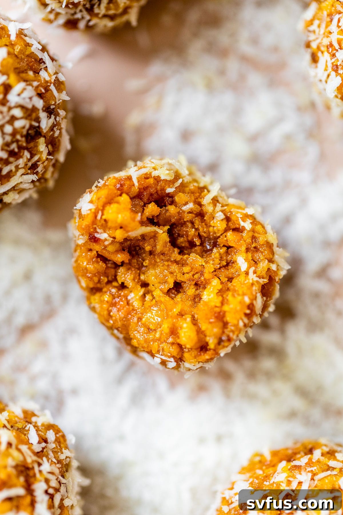 A delicious no-bake energy ball with a bite taken out, revealing its rich, chewy texture.
