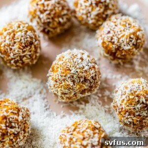 mango balls on a plate covered in shredded coconut