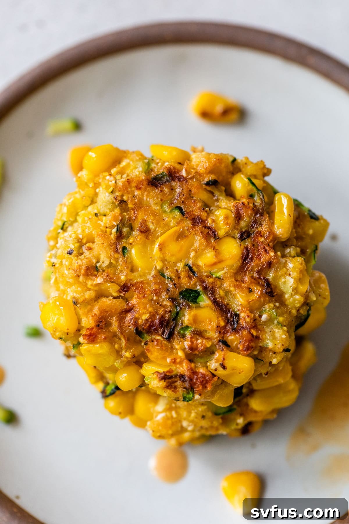 a close up photo of a zucchini corn fritter