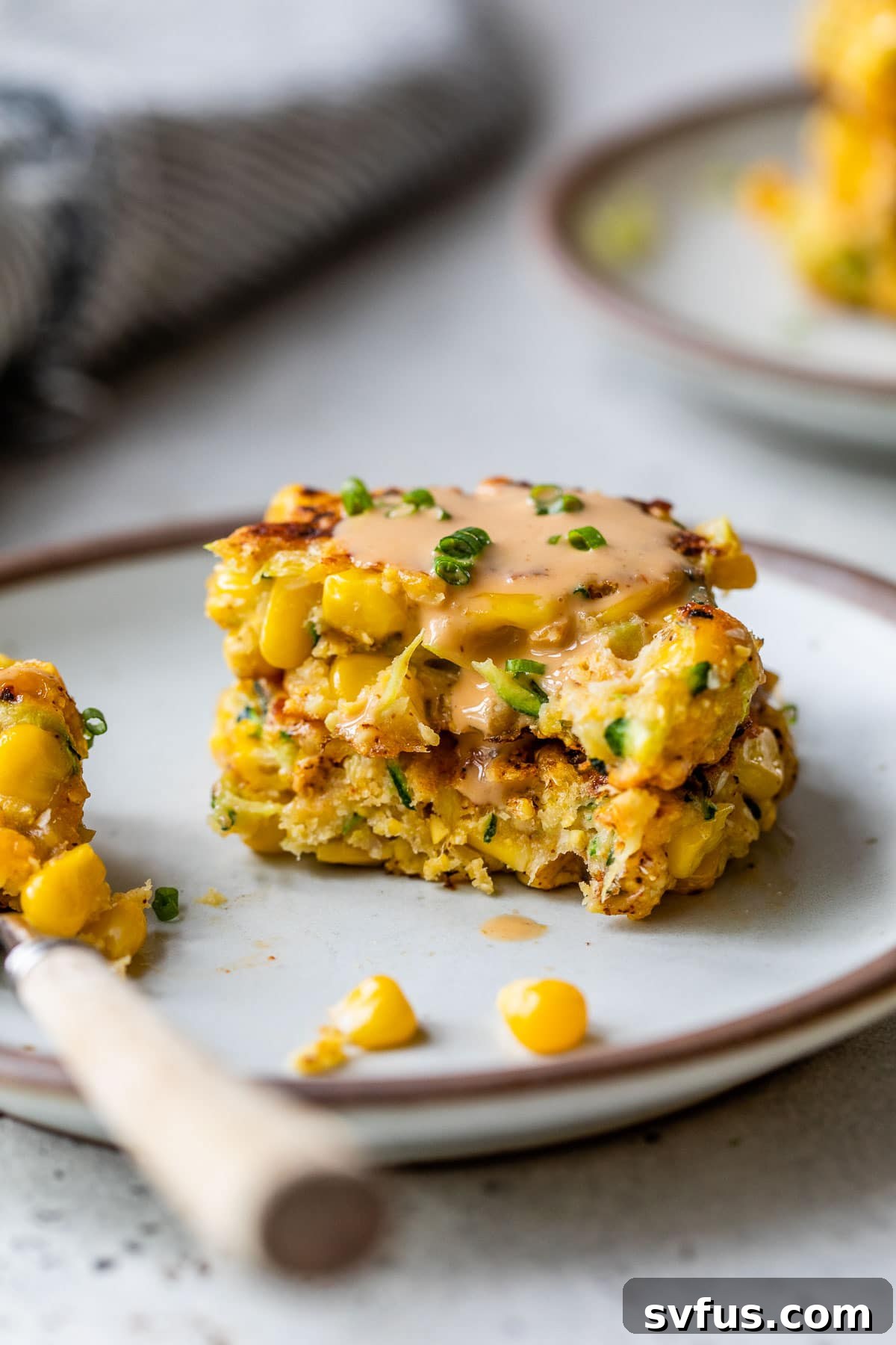 a zucchini corn fritter with a bite taken out of it