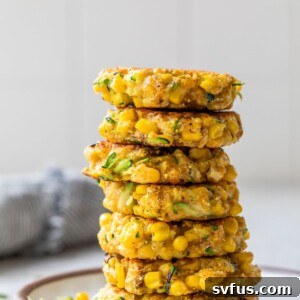 a large stack of fritters on a small white plate