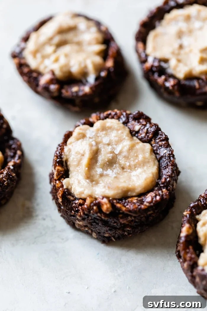 Decadent chocolate thumbprint cookies with a caramel filling, ready to eat.