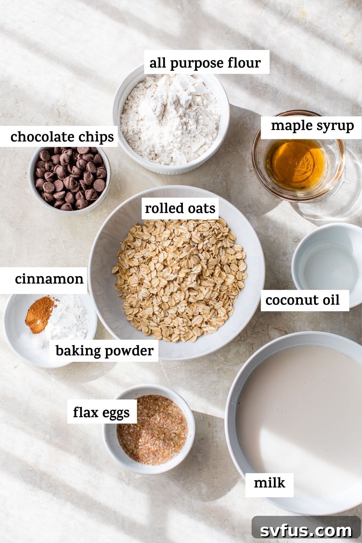 A selection of fresh ingredients laid out on a clean surface, including oats, milk, maple syrup, and other pancake essentials, ready for preparation.