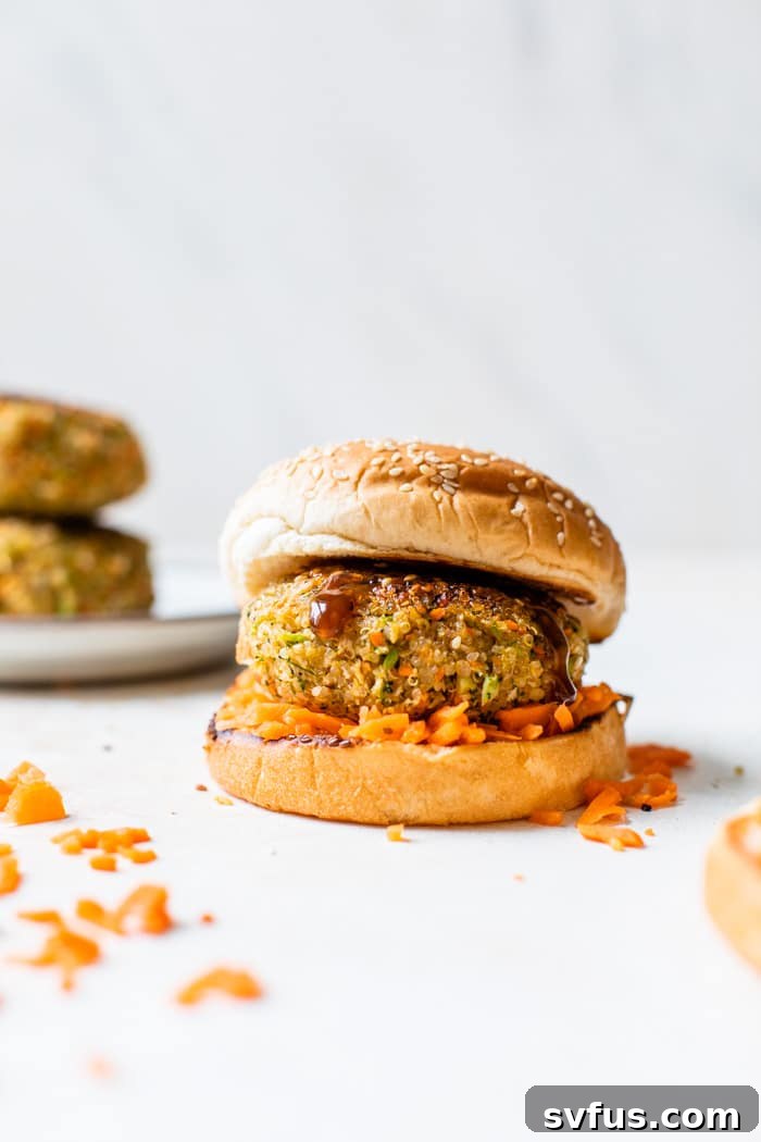 Burger on a bun with shredded carrots around it, showcasing a complete and appetizing meal