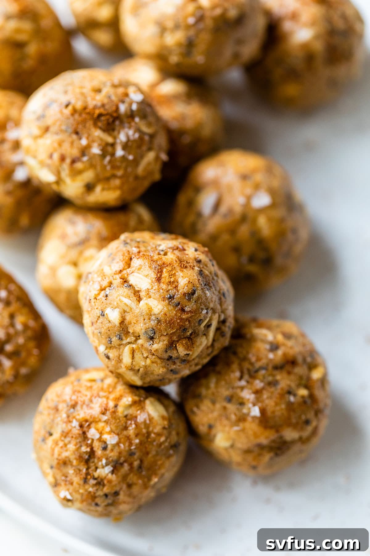 several energy balls made with nut butter and oats on a white plate