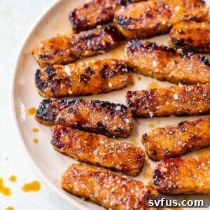 sliced tempeh with grill marks on a pink plate